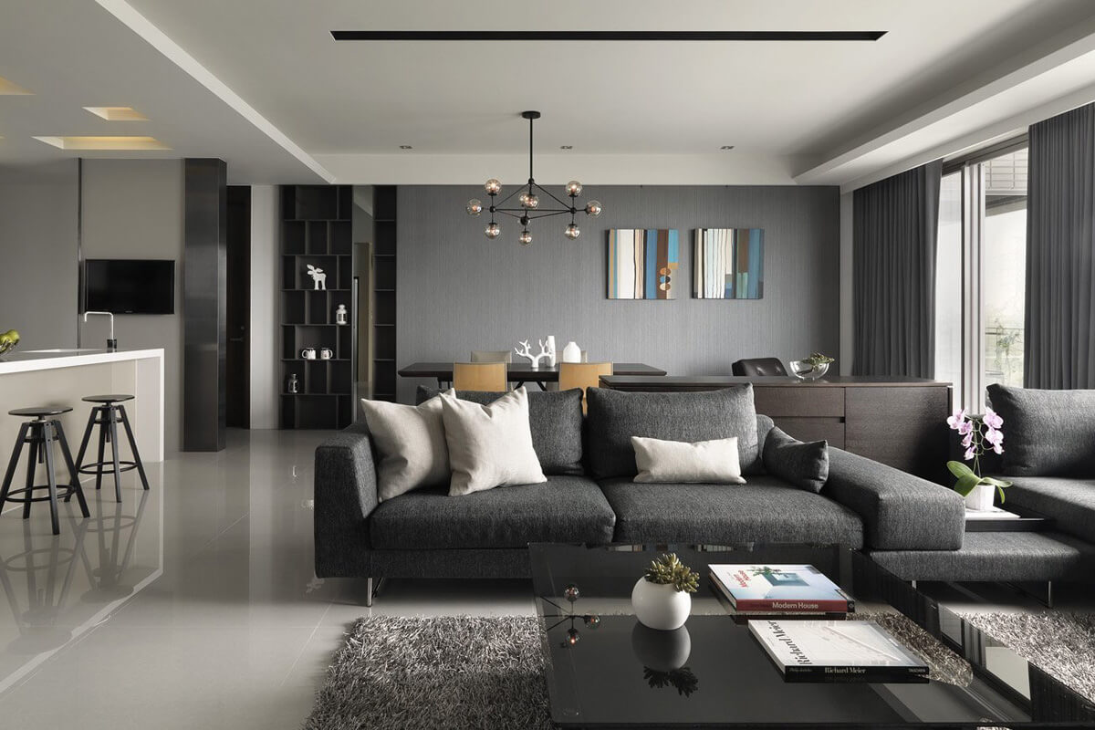 Oaza spokoju w salonie Szaro-biały salon w stylu nowoczesnym z wygodną sofą i dekoracyjnymi poduszkami