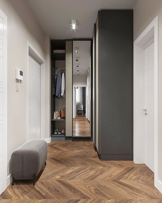 Minimalizm w przedpokoju Minimalistyczna szafa do przedpokoju z gładkimi frontami bez uchwytów w małym przedpokoju.