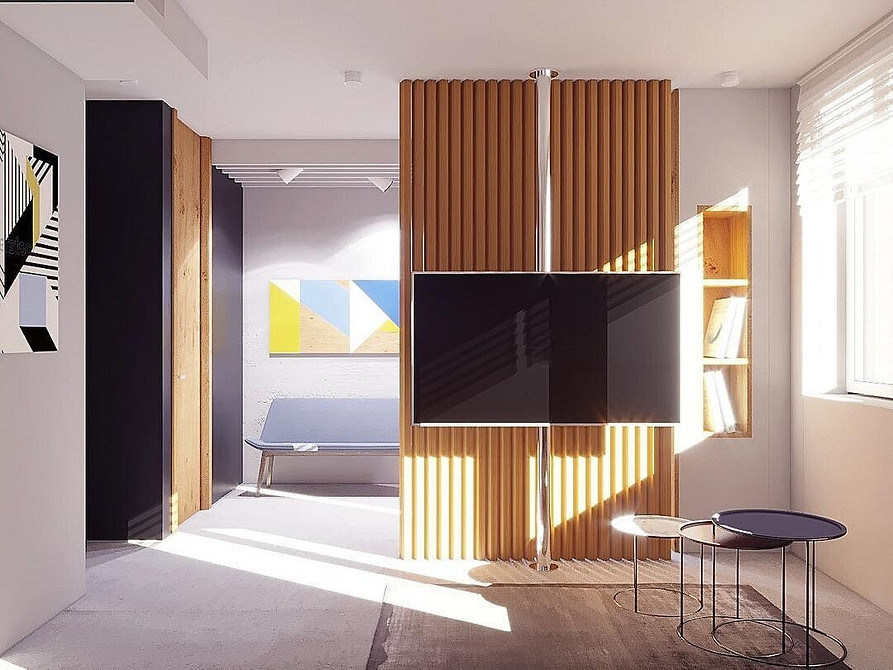 Minimalizm i natura Telewizor ukryty w szafie w stylu skandynawskim z naturalnych materiałów w małym mieszkaniu.