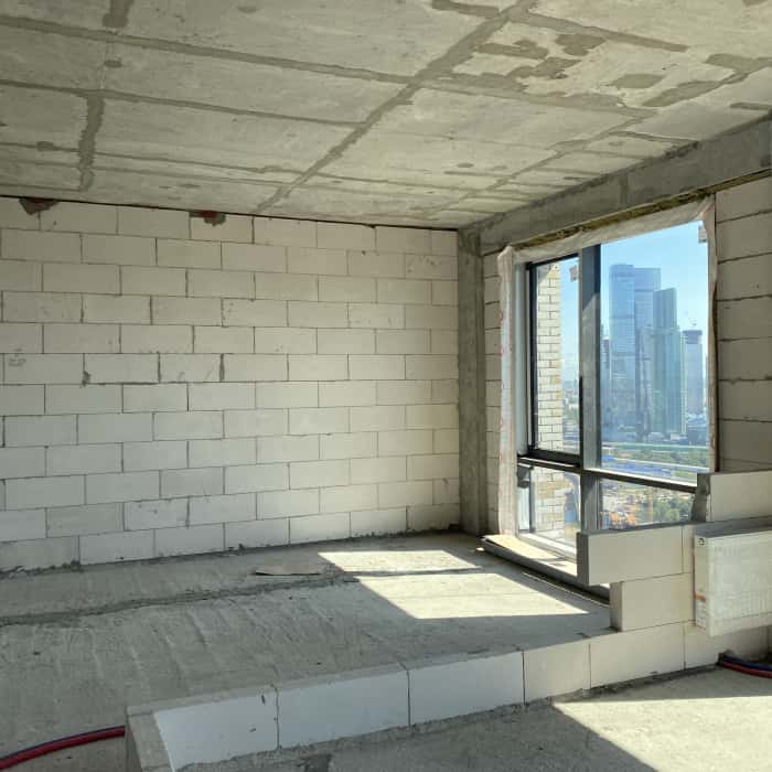 Szarość i beton Szaro-brązowe wnętrze: betonowe ściany w małym mieszkaniu w stylu nowoczesnym.