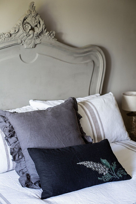 Minimalistyczne łóżko szare Eleganckie szare łóżko z metalowym stelażem w minimalistycznej sypialni.